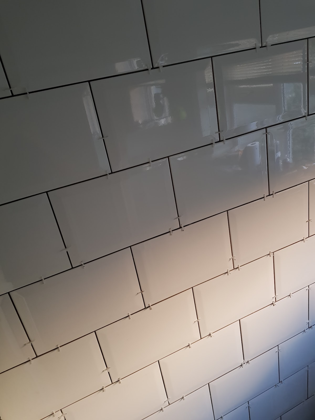 Wall tiling in progress with spacers visible